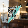 Green Bay Life text and outline of Green Bay on a window.