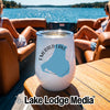 A white wine tumbler with an Emerald Lake graphic sits on a wooden boat table.