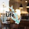 Sticker with "Randleman Life" text and a teal lake outline on glass.