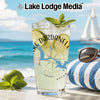 Glass with Dardanelle lake map and compass, beach scene, sunglasses and pillow.