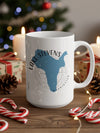White mug with blue Lake Stevens, Washington map design, surrounded by holiday decorations.