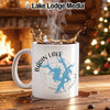White mug with Badin Lake map and compass, steaming coffee splashing.