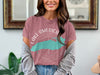 Pink t-shirt with a turquoise map graphic and compass, text reads "LAKE AMERICA".