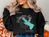 Black sweatshirt with "Whiskeytown Lake" map and compass graphic.