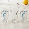 Three clear glasses each featuring a blue map of Abraham Lake, Alberta and a compass rose.