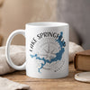 White mug with Lake Springfield Missouri map and compass design, steam rising.