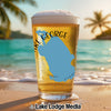 Glass of beer on beach with blue Florida map design and "Lake George" text.