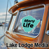 Turquoise "Mary Life" sticker on a wooden boat window with "Lake Lodge Media" logo below.
