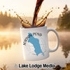White mug with Jordan Pond Maine map and compass design, coffee pouring.