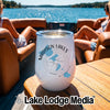 A white insulated wine tumbler with a Madison Lakes graphic sits on a wooden boat table.