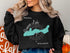 Black sweatshirt with compass and "Beautiful Geneva Lake Wisconsin" map.