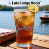 Glass of iced tea with lake map design and lemon slice on a table.