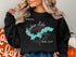 Black sweatshirt with a turquoise map of Ashokan Lake and compass rose.