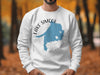 White sweatshirt featuring a blue Lake Simcoe map and compass design.