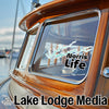 Sticker on boat window reads "Norris Life" with graphic; "Lake Lodge Media" text below.