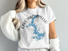 White t-shirt with blue Lake of the Ozarks map and compass graphic.