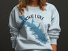Light blue sweatshirt with Waurika Lake Oklahoma map and compass graphic.