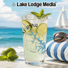 Glass with Lake Anna map design, beverage, lime, mint, sunglasses, pillow on beach.