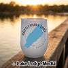 A white stemless wine tumbler with a blue map of Rattlesnake Lake, Washington, sits on a wooden dock.