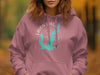 Dusty rose hoodie with a teal outline map of Texas and compass design.