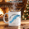 White mug with Lake Marble Falls Texas design and compass, steaming hot coffee splashing.