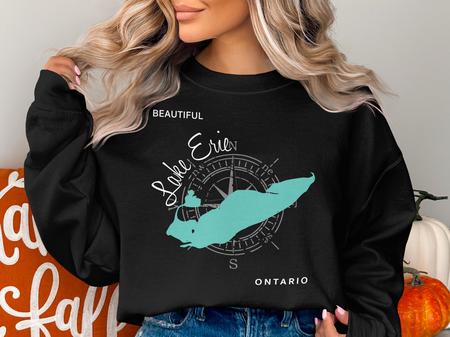Black crewneck sweatshirt with a turquoise Lake Erie map and compass rose graphic.