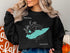 Black crewneck sweatshirt with a turquoise Lake Erie map and compass rose graphic.