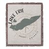 Woven blanket with Lake Erie map outline, compass rose, and text.
