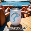 A white insulated tumbler featuring a blue map graphic and Lake Pend Oreille Idaho text rests on a wooden boat table.