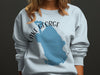 Light blue sweatshirt with a blue Lake George outline and "FLORIDA" text.
