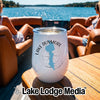 A white insulated wine tumbler with a Lake Dunmore, Vermont graphic resting on a boat table.