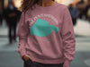 Pink sweatshirt with teal Lake Pontchartrain graphic and compass rose.