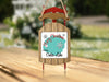Sled ornament with "Merry Christmas FROM Crater Lake" text and snowflakes.