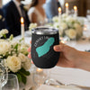 Black tumbler with Convict Lake California map and compass graphics, held by a hand.