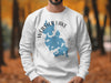 White sweatshirt with a blue outline of Webster Lake, Massachusetts, and compass graphic.