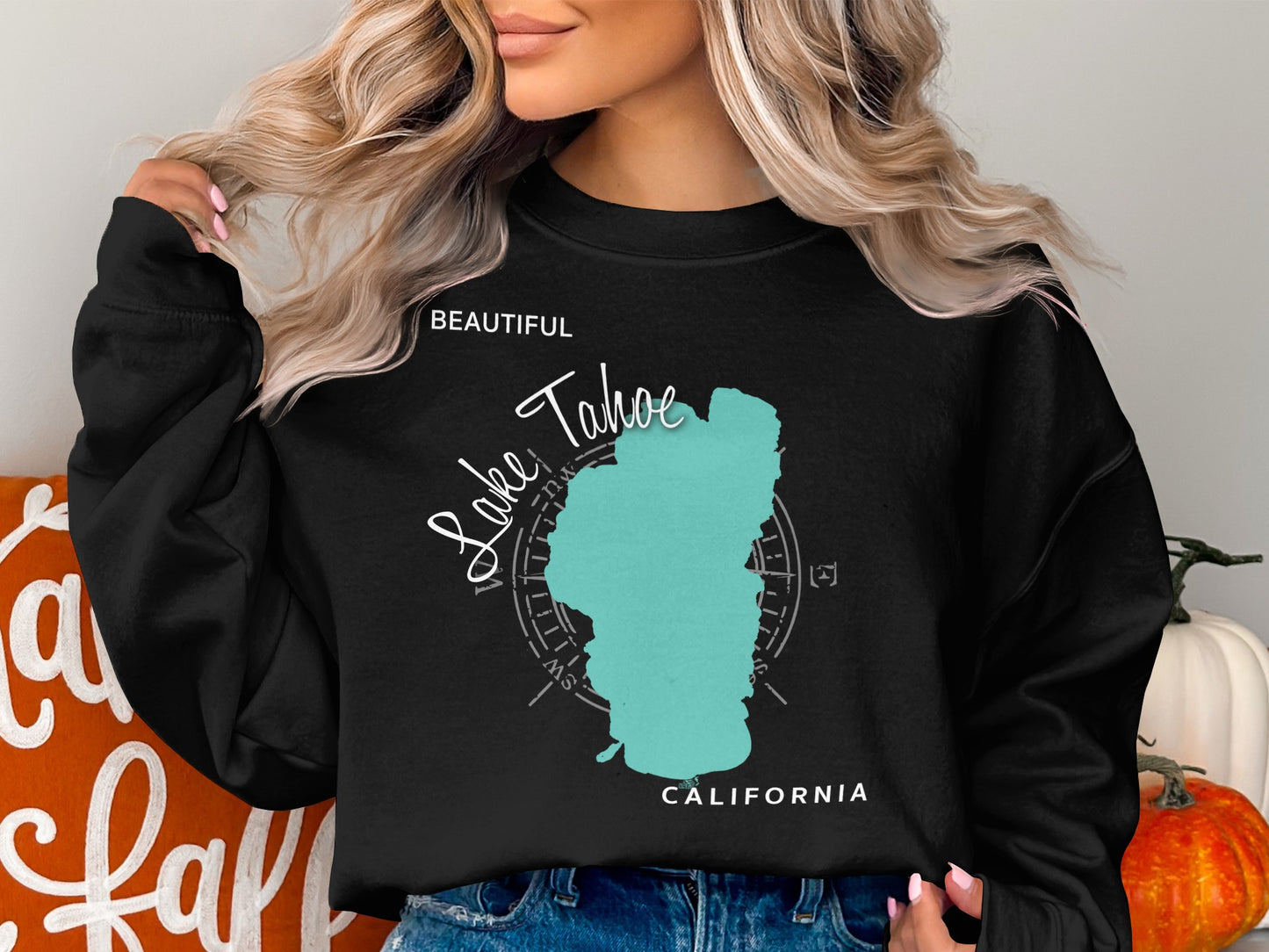 Black sweatshirt with a turquoise outline of Lake Tahoe and compass rose.