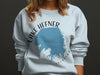 Light blue sweatshirt with Lake Hefner Oklahoma map graphic and compass.