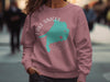 Pink crewneck sweatshirt with Lake Simcoe Ontario map and compass graphic.