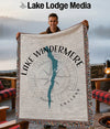 Man holding a blanket with Lake Windermere map and compass rose design.