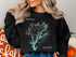Black sweatshirt with "Beautiful West Point Lake Georgia" and compass graphic.