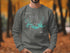 Gray sweatshirt with "Beautiful Lake Amistad Texas" map and compass graphic.