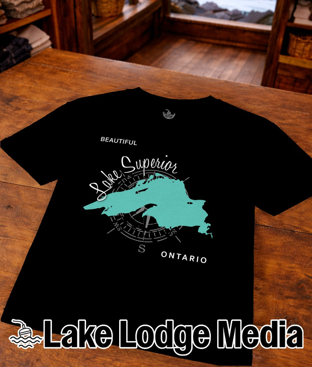 Black t-shirt with turquoise Lake Superior map and compass graphic, "Lake Lodge Media" text.