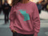 Pink sweatshirt with teal Lake Lawtonka, Oklahoma map and compass graphic.