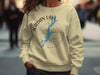 Light yellow sweatshirt with Jordan Lake map and compass graphic.