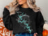 Black sweatshirt with Lake Tuscaloosa, Alabama map and compass graphic.