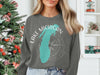 Grey sweatshirt with turquoise Lake Michigan outline and compass graphic.