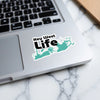 Key West Life sticker on a laptop keyboard.