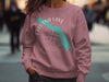 Pink sweatshirt with Eklutna Lake map graphic and compass in white and teal.