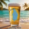 Glass of beer with Lake Derwent map and compass design on a beach.
