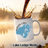 White mug with Indian Lake map and compass design, coffee splashing in.